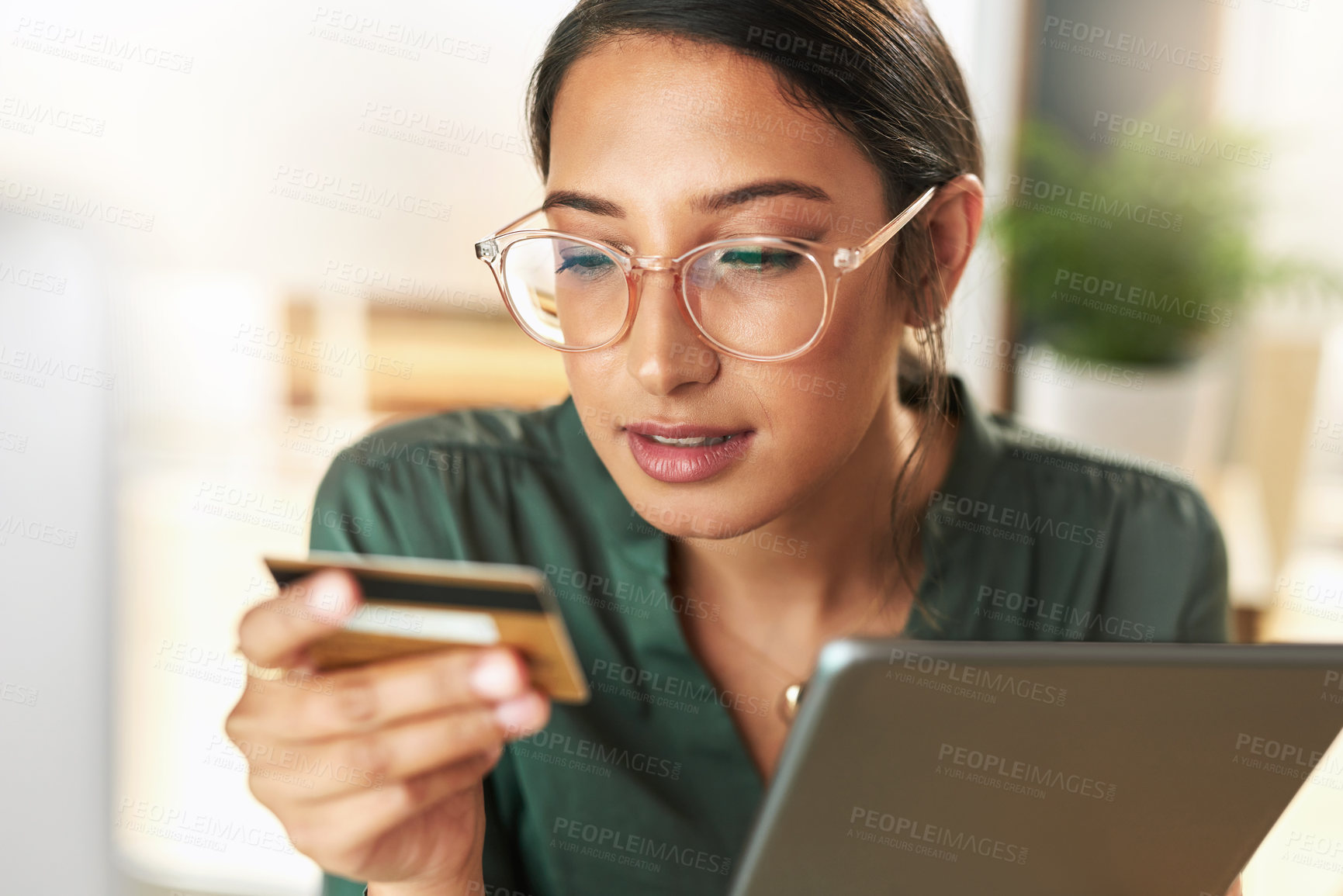 Buy stock photo Shot of a young businesswoman using her digital tablet to shop online