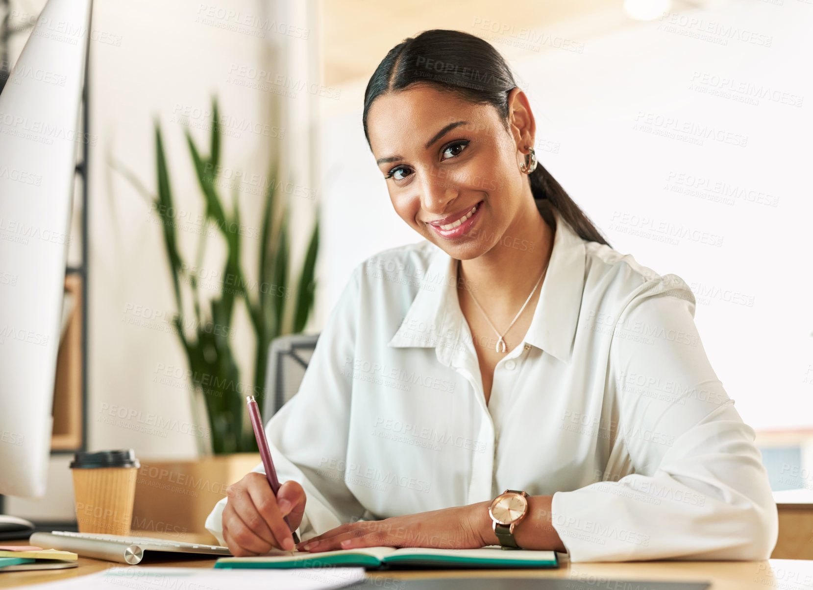 Buy stock photo Shot of a young businesswoman compiling notes at work