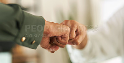 Buy stock photo Shot of two businesswomen fist bumping each other in greeting