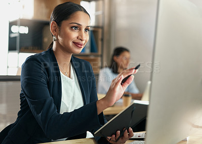 Buy stock photo Shot of a businesswoman comparing her notes with data on her PC screen