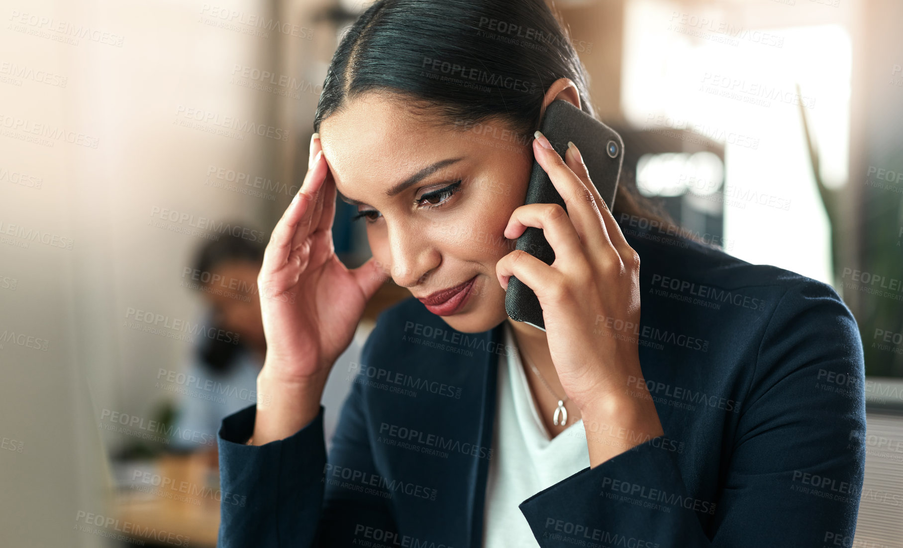 Buy stock photo Shot of a young businesswoman taking a call on her smartphone at work