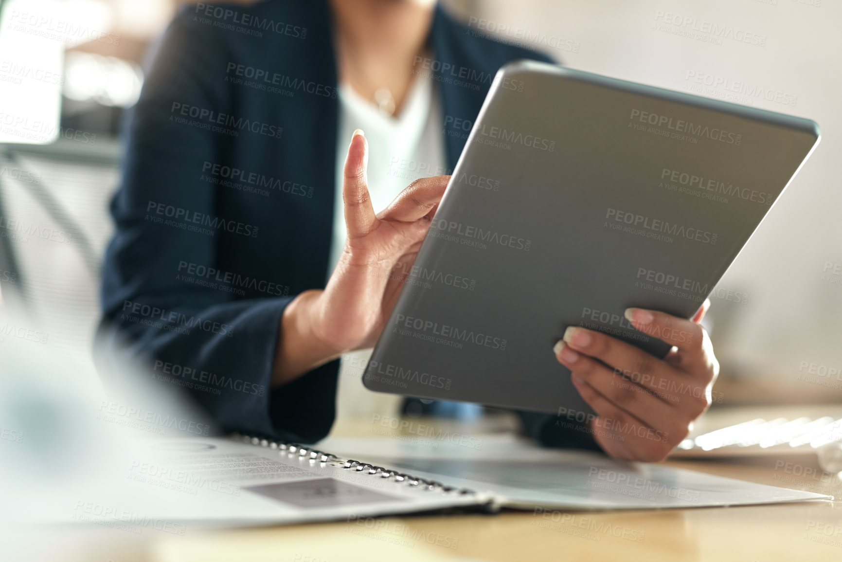 Buy stock photo Shot of a businesswoman using her digital tablet at her desk