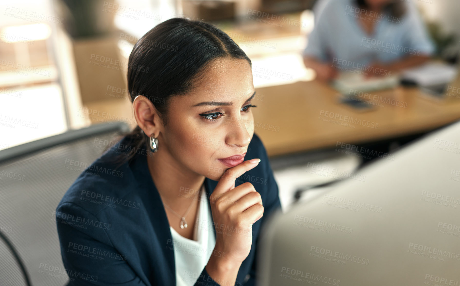 Buy stock photo Shot of a young businesswoman at her desk in the office