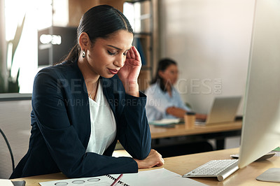 Buy stock photo Shot of a young businesswoman experiencing a headache at work