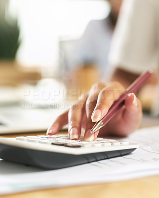 Buy stock photo Shot of a businesswoman using a calculator to budget her finances
