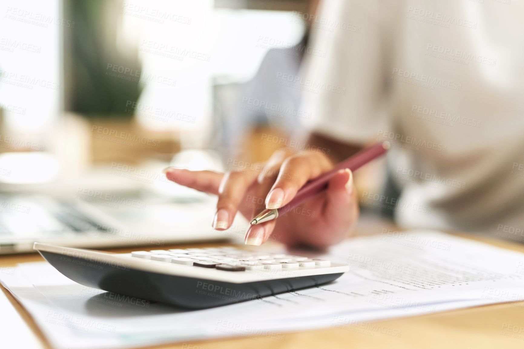 Buy stock photo Shot of a businesswoman using a calculator to budget her finances