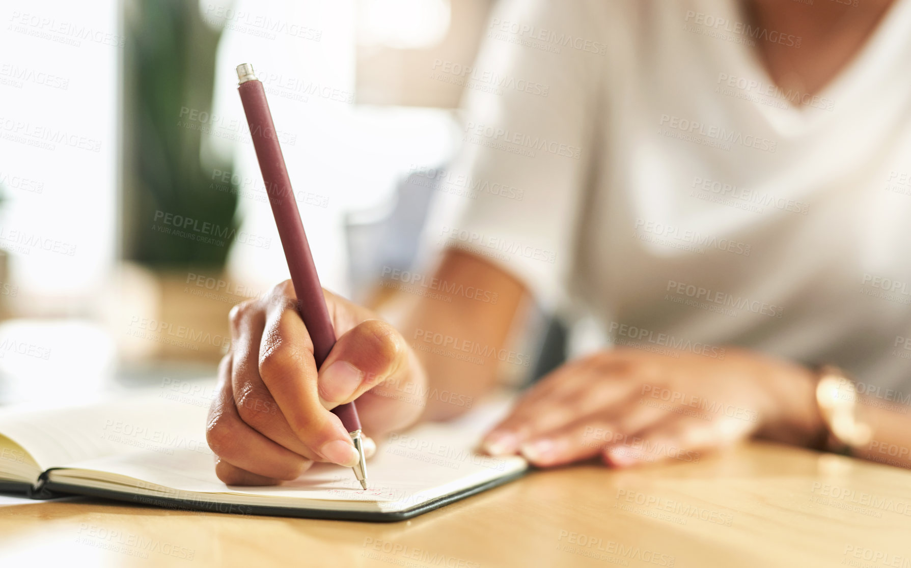 Buy stock photo Shot of a businesswoman making notes in her notebook