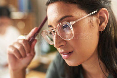 Buy stock photo Shot of a young businesswoman day dreaming at her desk
