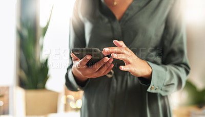 Buy stock photo Shot of a businesswoman using her smartphone