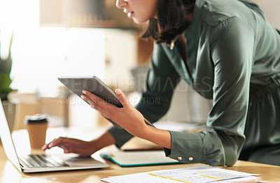 Buy stock photo Shot of a businesswoman using her digital tablet at her desk