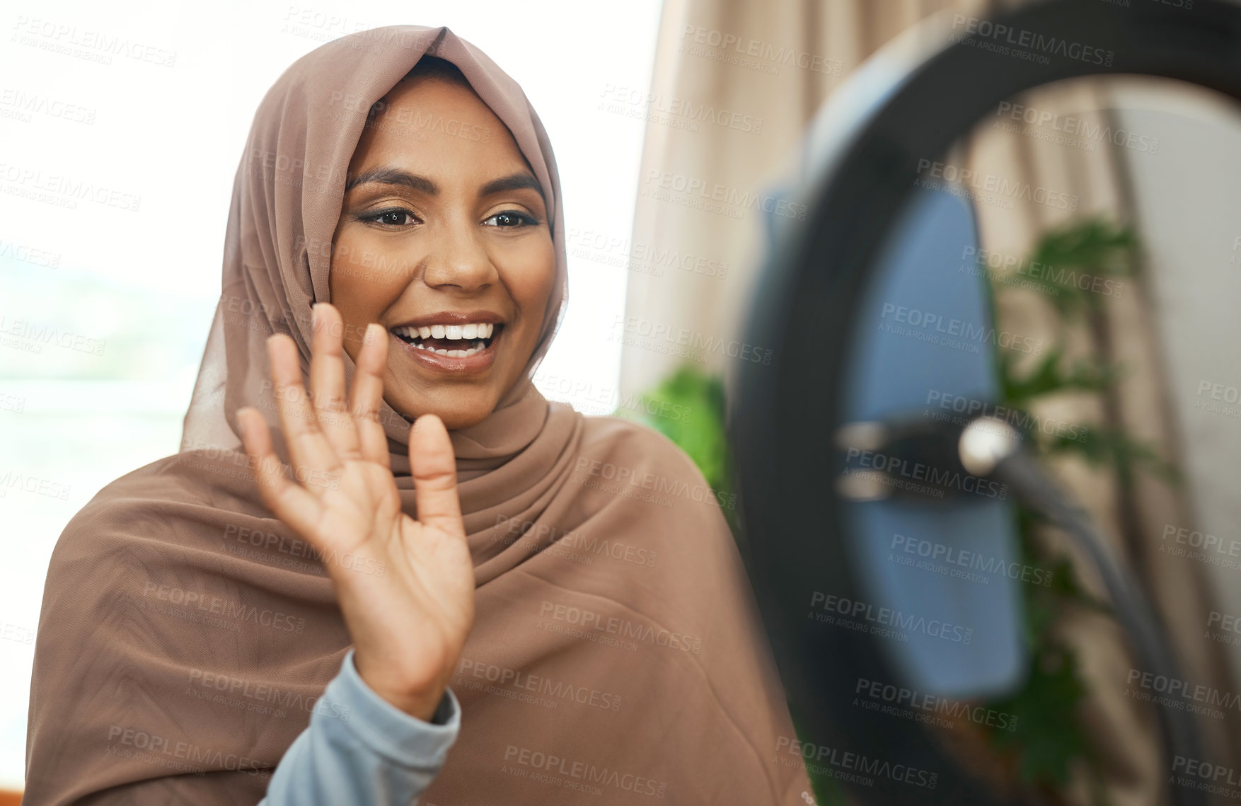 Buy stock photo Shot of a young muslim female busy recording her for her vlog