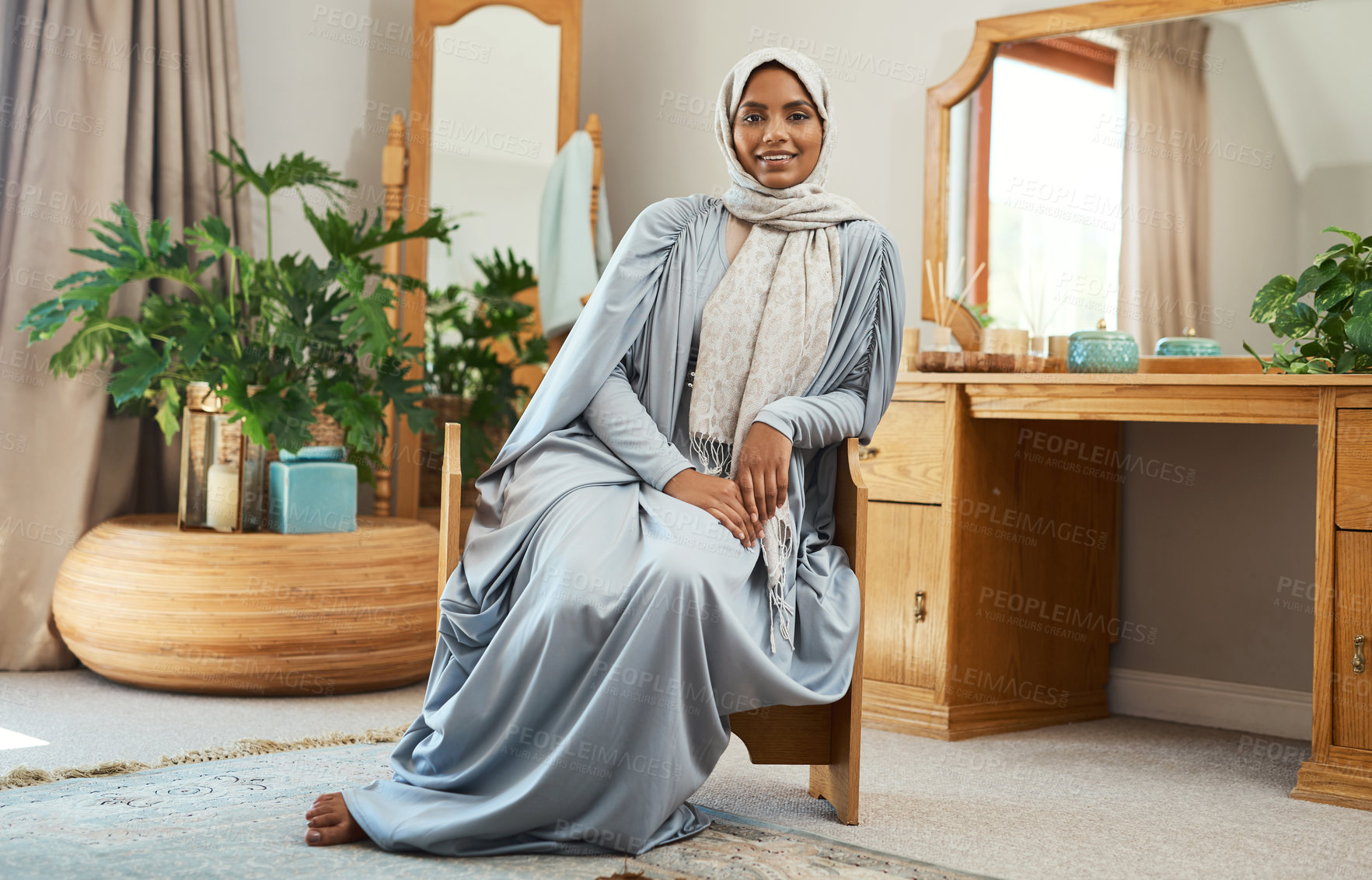 Buy stock photo Shot of a young muslim woman sitting in the loung at home