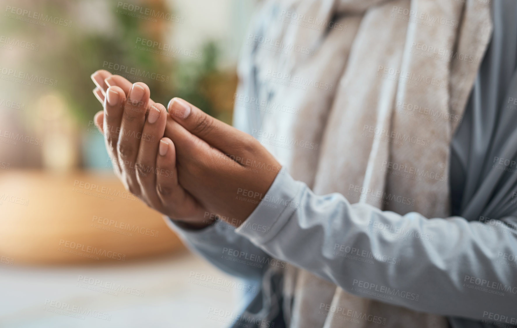 Buy stock photo Shot of an unrecognizable woman praying at home