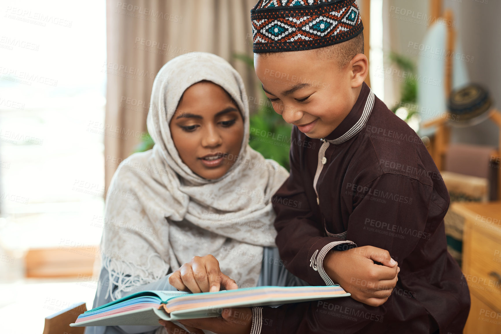 Buy stock photo Shot of a young muslim mother spending time with her son at home