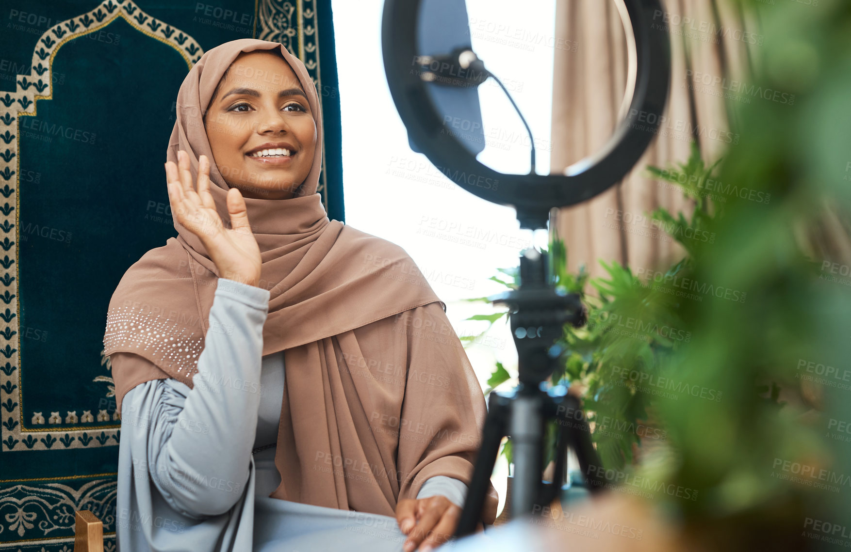 Buy stock photo Shot of a young muslim female busy recording her for her vlog