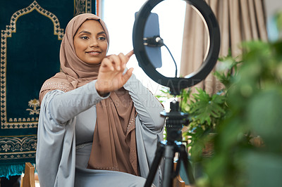 Buy stock photo Shot of a young muslim female busy recording her for her vlog