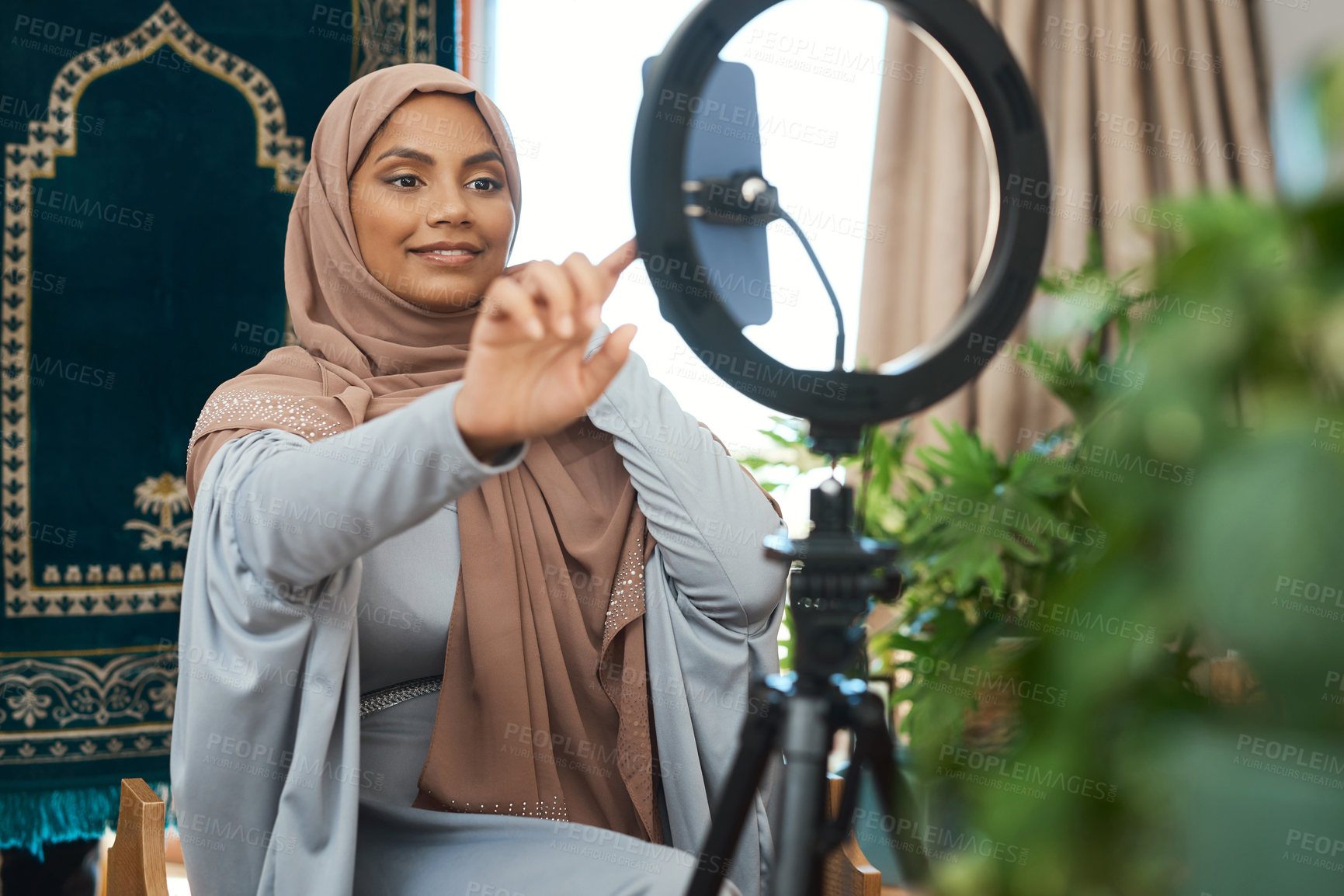 Buy stock photo Shot of a young muslim female busy recording her for her vlog