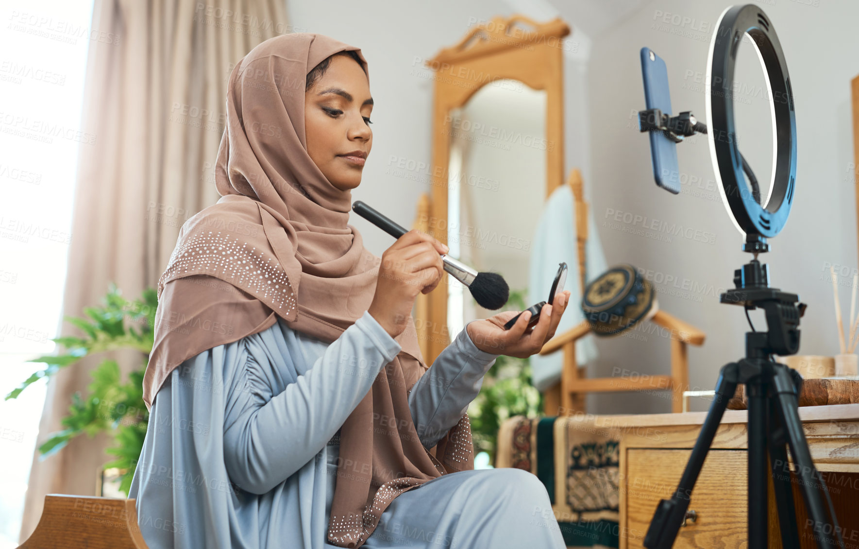 Buy stock photo Shot of a young muslim female busy recording her for her vlog