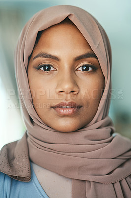 Buy stock photo Shot of a young muslim woman sitting in the loung at home