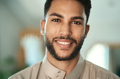 Buy stock photo Shot of a young muslim woman standing in the loung at home