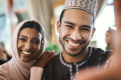 Buy stock photo Shot of a young muslim couple taking selfies together