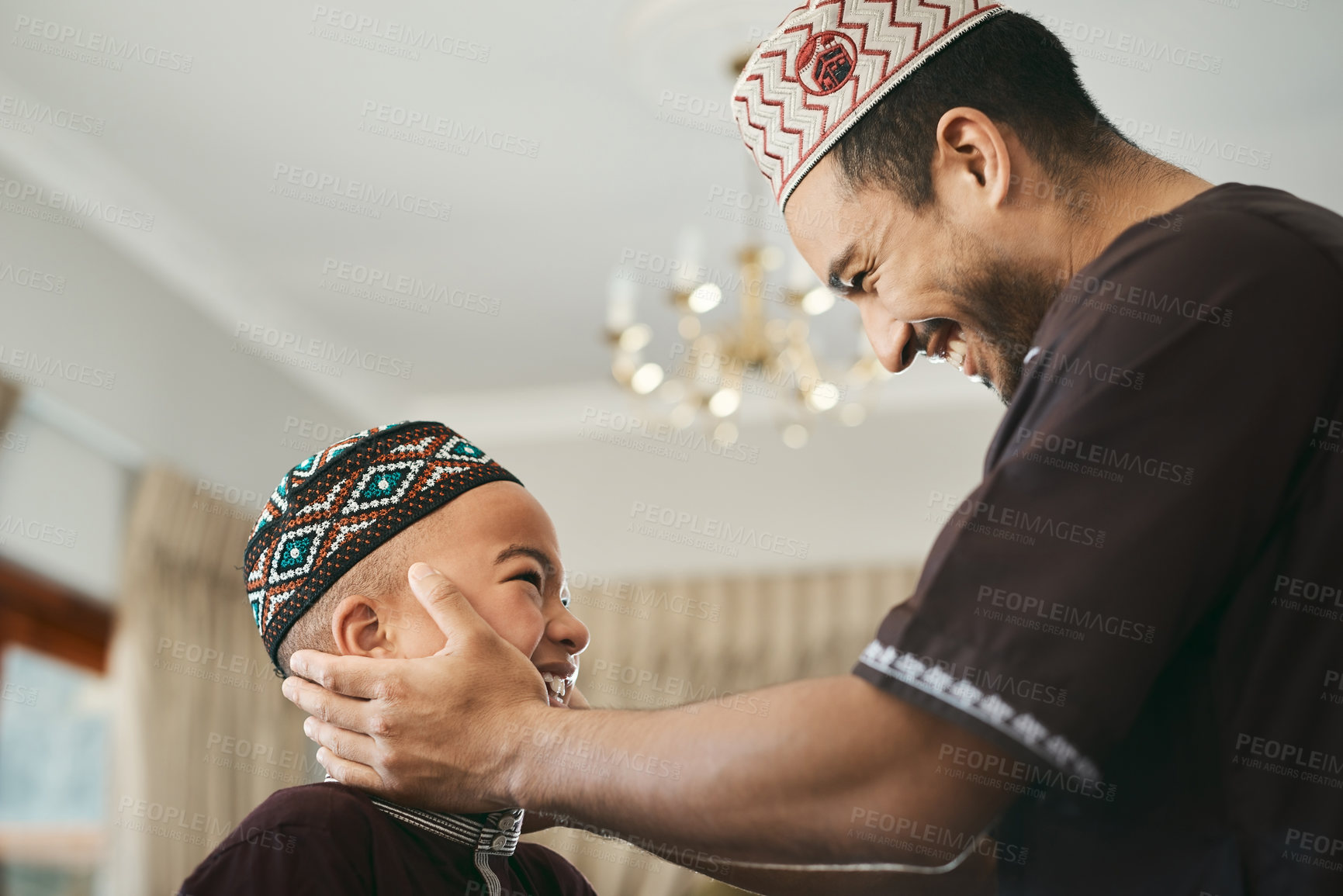 Buy stock photo Shot of a muslim father gazing affectionately at his son