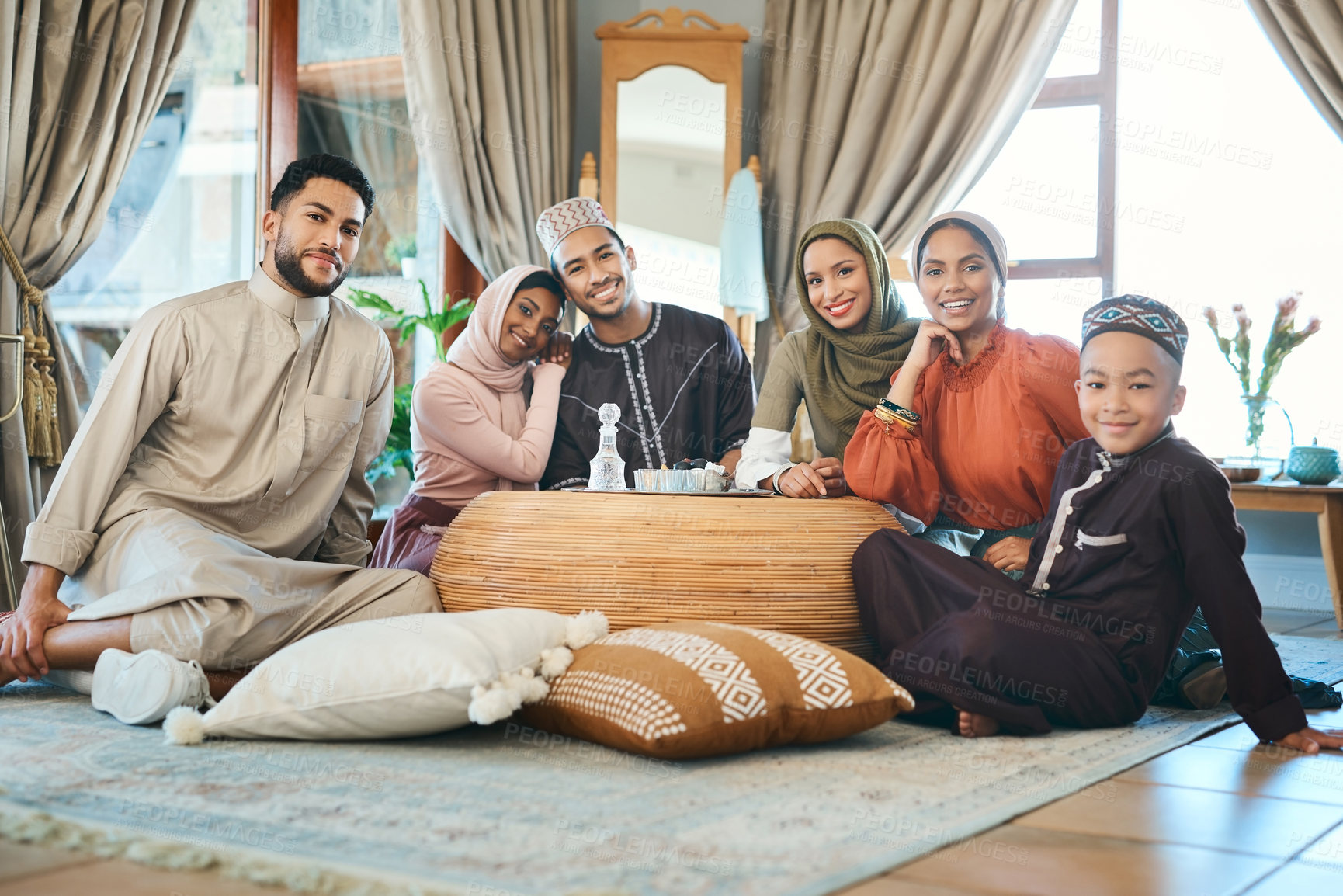 Buy stock photo Shot of a young muslim family relaxing together during ramadan