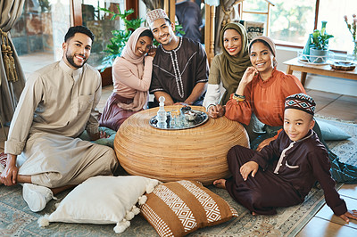 Buy stock photo Happy muslim family celebrating ramadan together, smiling and bonding in living room. Relaxed relatives spending the day embracing religious holiday. Islamic siblings gathering in their family house