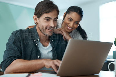 Buy stock photo Shot of a young couple using a laptop at home