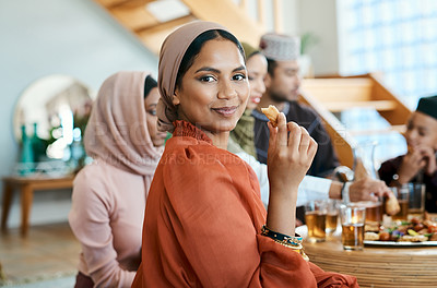 Buy stock photo Shot of a young muslim woman enjoying lunch with her family