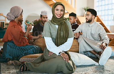 Buy stock photo A happy Muslim woman sitting, with family and celebration of culture during Ramadan. A modern Islamic lady with a smile, beauty and in a hijab to celebrate holiday and eat together and home for Eid
