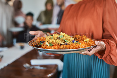 Buy stock photo Shot of a muslim woman holding a plate of food