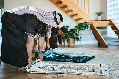 Buy stock photo Shot of a group of muslim men placing down their prayer mats in preparation