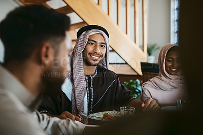 Buy stock photo Muslim, arab and islamic man enjoying a meal for eid, ramadan or breaking fast with family while celebrating religion, holy culture and islam faith. Happy, smiling and spiritual guy eating lunch