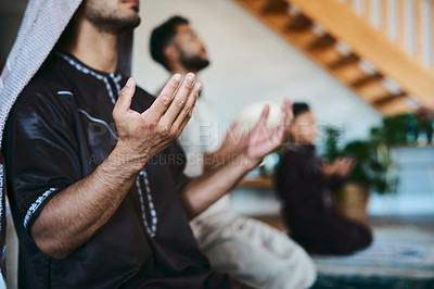 Buy stock photo Shot of a group of muslim male family members praying together