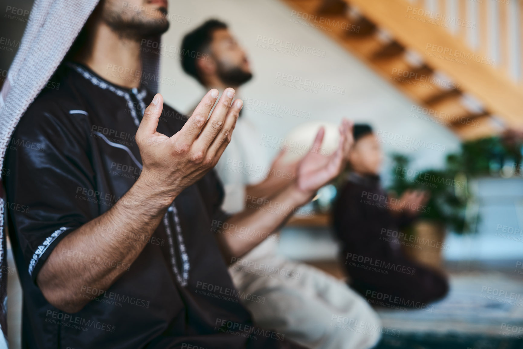 Buy stock photo Shot of a group of muslim male family members praying together