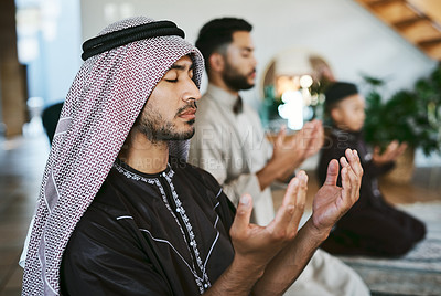 Buy stock photo Shot of a group of muslim male family members praying together