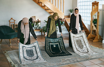 Buy stock photo Shot of a group of muslim women laying down their prayer mats in preparation