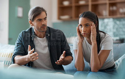 Buy stock photo Shot of a young couple having an argument at home