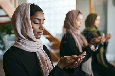 Buy stock photo Praying, muslim and young women group practicing arabic, holy and islamic religion indoors. Females wearing a hijab while kneeling to practice a quiet, spiritual and worship prayer inside in silence