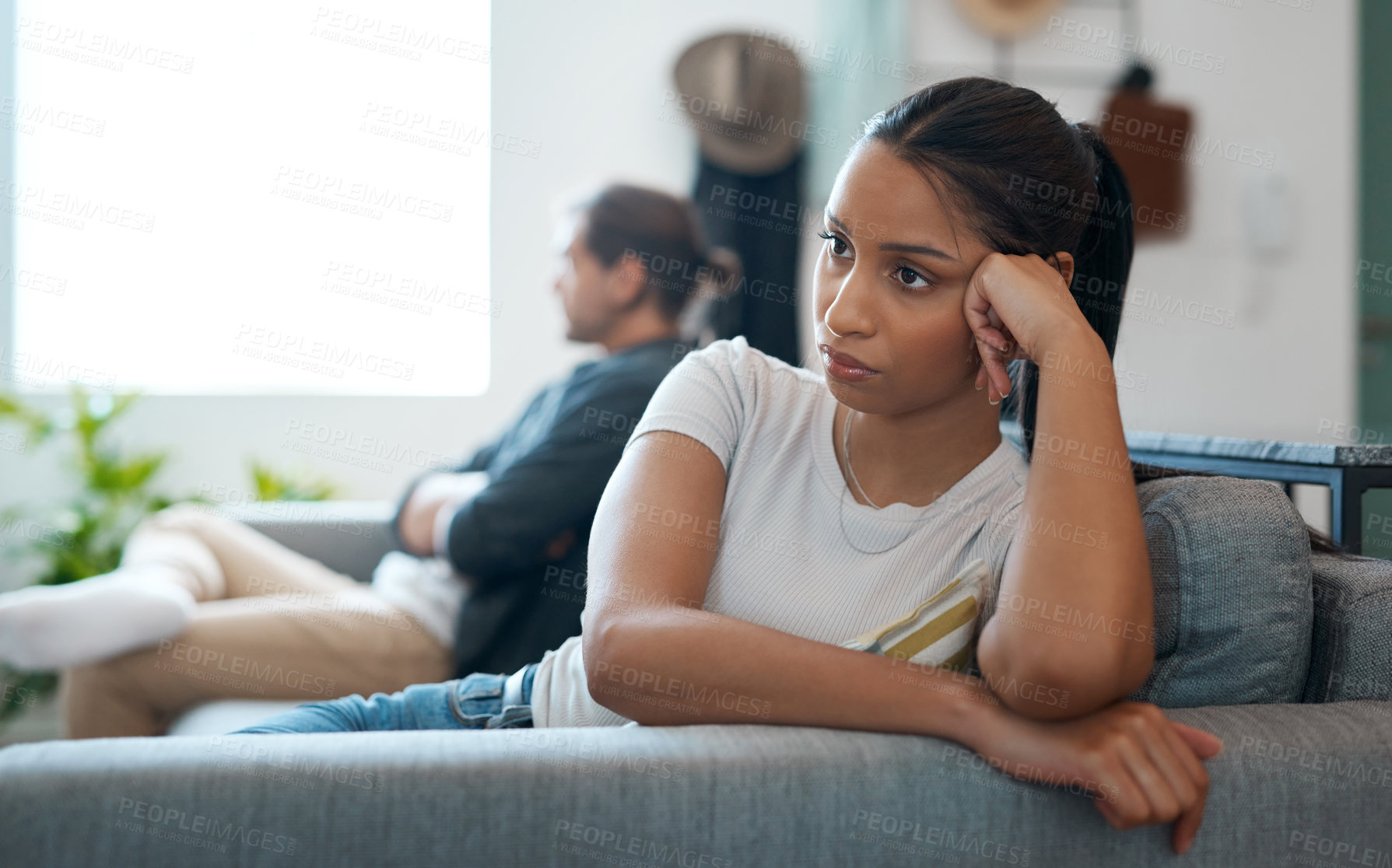 Buy stock photo Shot of a young couple having an argument at home