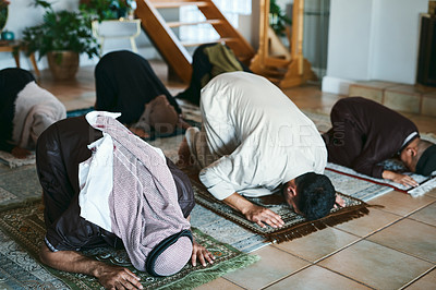 Buy stock photo Shot of a group of muslim family members praying together