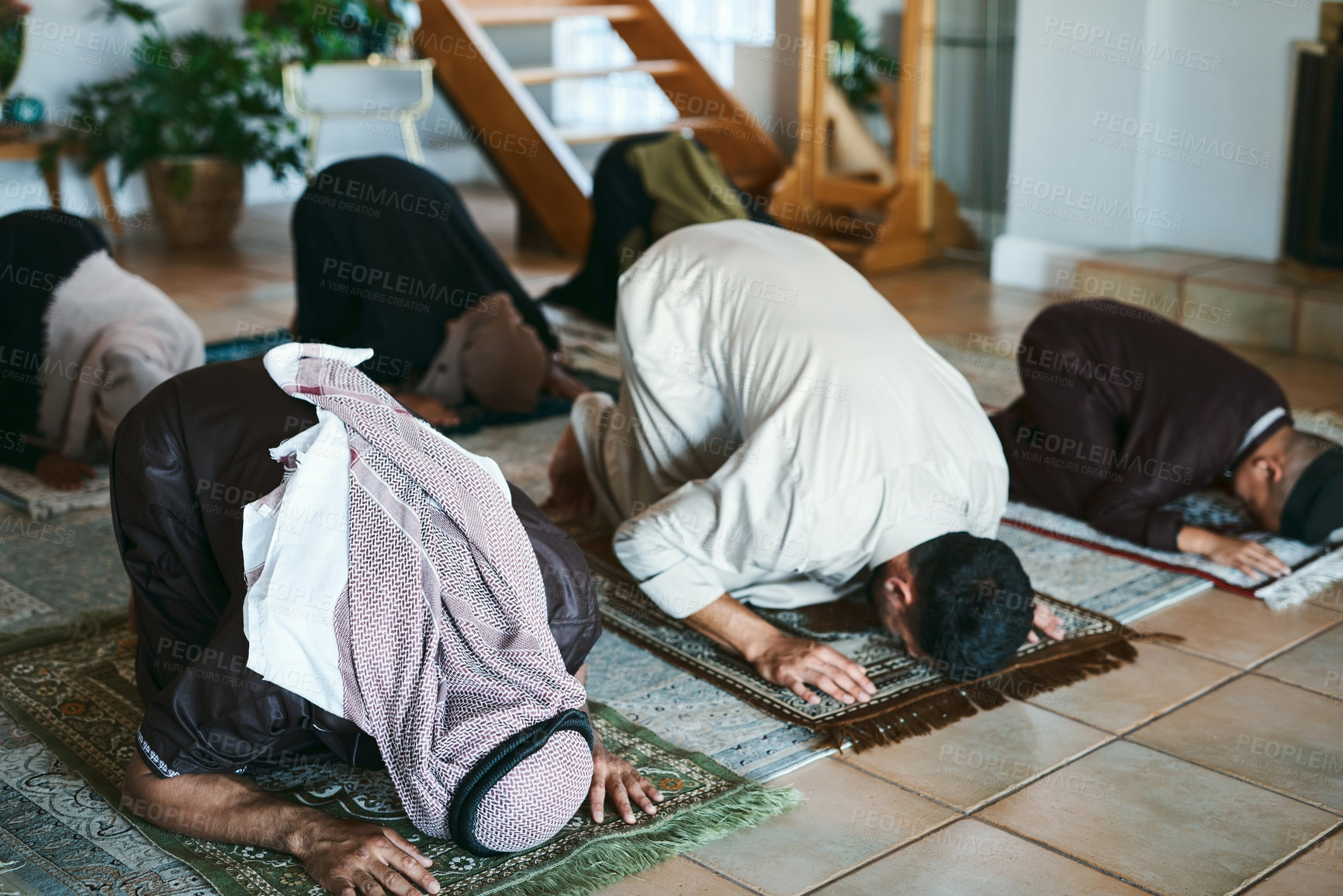 Buy stock photo Shot of a group of muslim family members praying together