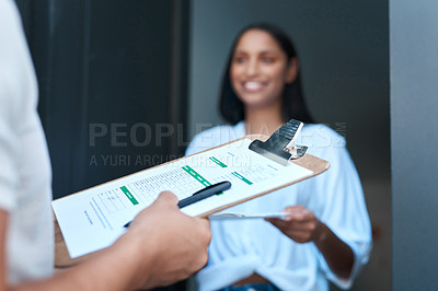 Buy stock photo Shot of a young woman receiving a delivery at home