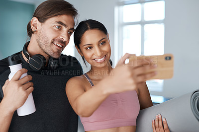 Buy stock photo Cropped shot of an athletic young couple taking selfies before starting their workout at home