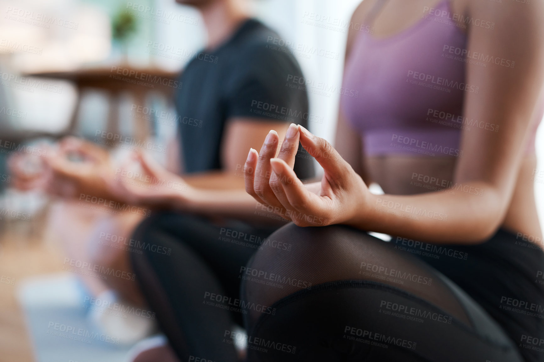 Buy stock photo Cropped shot of an unrecognizable and athletic young couple meditating during their workout at home