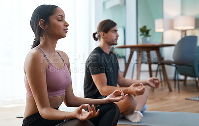Buy stock photo Cropped shot of an athletic young couple meditating during their workout at home
