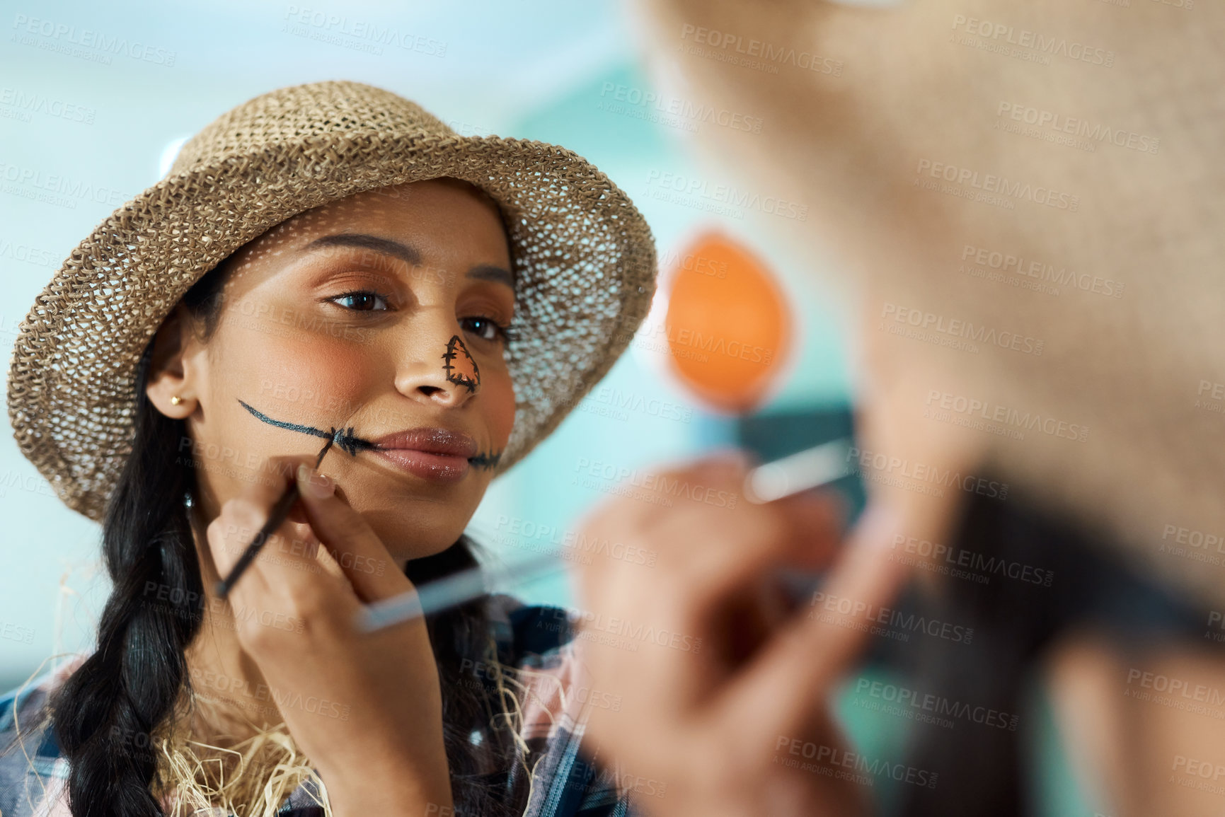 Buy stock photo Shot of a young woman applying halloween makeup at home
