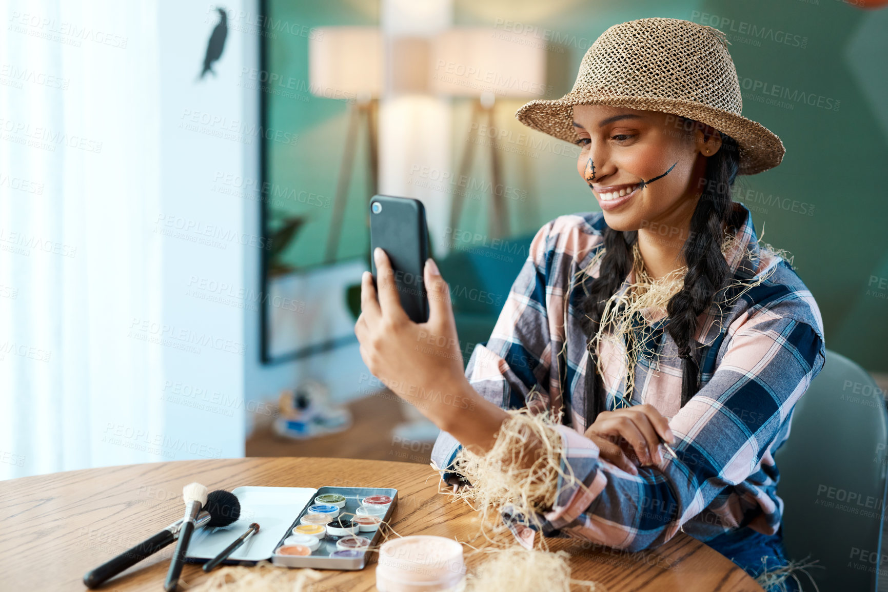 Buy stock photo Shot of a young woman taking a selfie while applying makeup at home