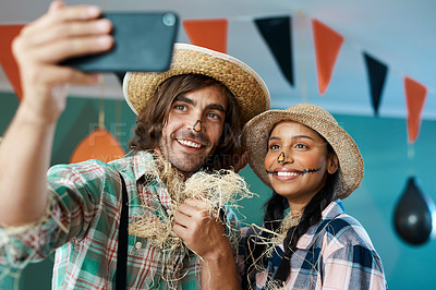 Buy stock photo Shot of a young couple taking a selfie at a home